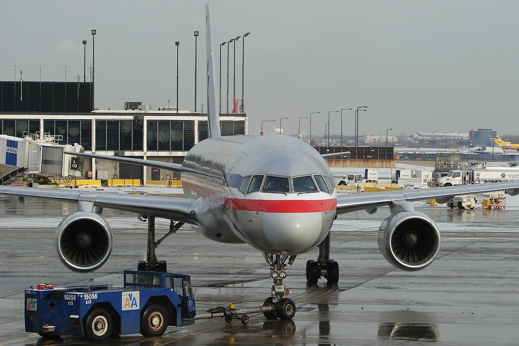 An image of an aircraft being pushbacked by a tug.